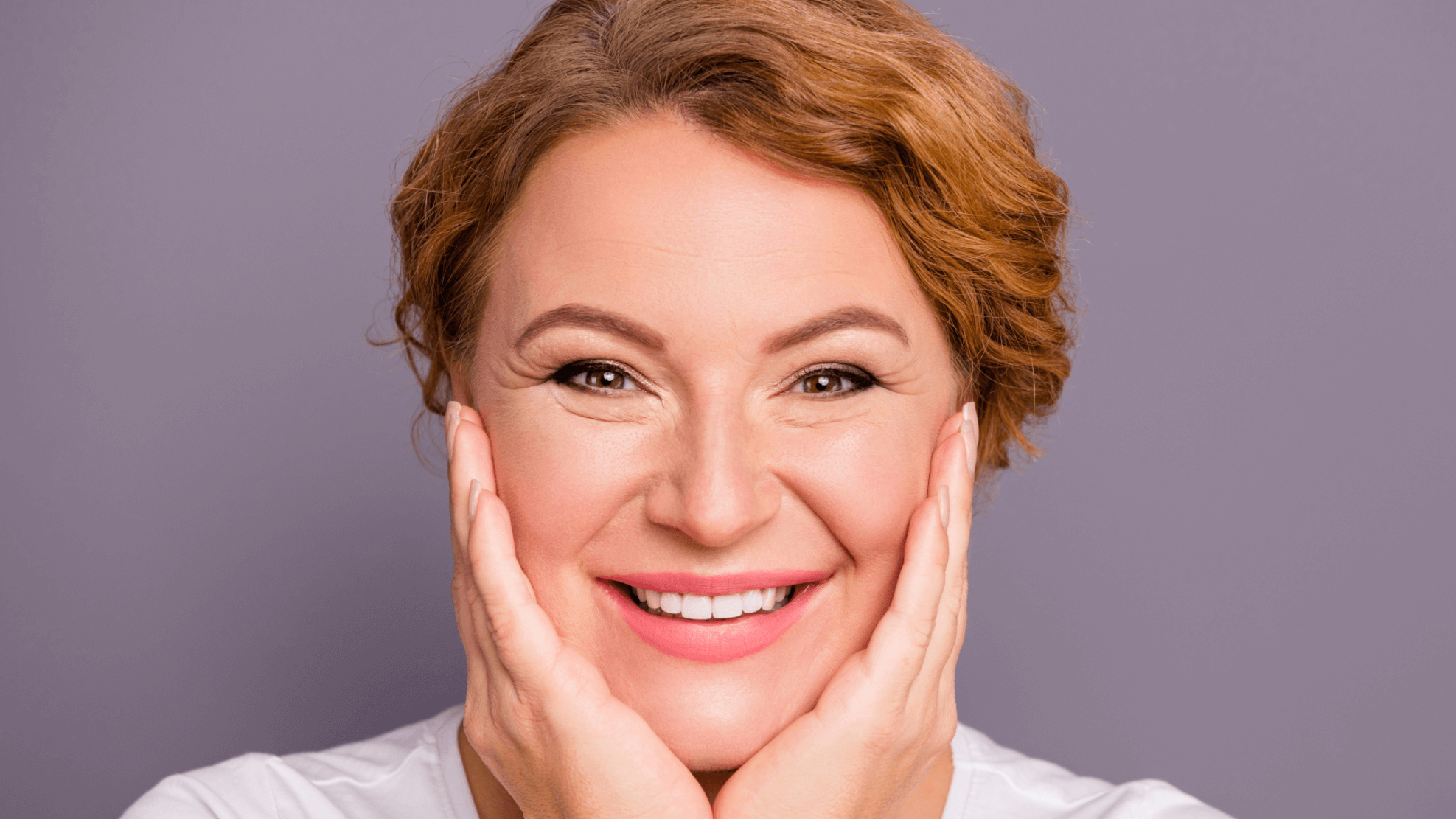 woman holding her face smiling